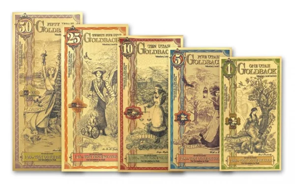 Utah Goldback notes in 1, 5, 10, 25, and 50 denominations, fanned on a white background with classical artwork on each note.